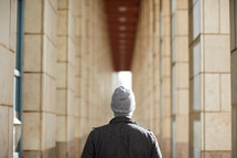 a man standing in a corridor 