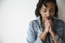 An African American woman in prayer 