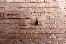Plank wall with rivets.