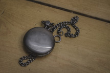 a pocket watch on a table 