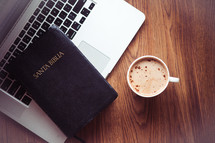 Santa Biblia, laptop, and cappuccino