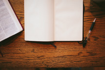open Bible, journal, pen