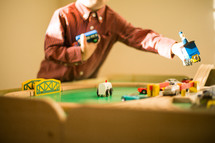 toddler boy playing with a toy train 