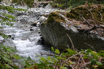 A stream of a river on a rocky bank