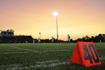 40 yard line on a football field at sunset.