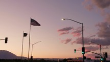 USA flag and gas station at sunset
