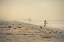 Surfer walking on the beach