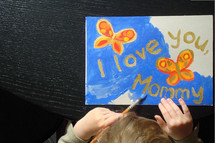 child painting a picture for mommy, 
picture, butterflies, Mother's Day, paint, painting, paintbrush, brush, yellow, orange, red, golden, present, gift, love, Mother's Day, mom, mother, mummy, mum, mommy, nice, lovely, fine, pleasant, fair, pretty, color, colour, colorful, multicolored