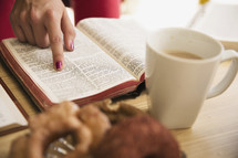 woman pointing to scripture and a coffee mug