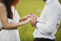 Hands together. Close-up of loving couple holding hands while walking outdoors. man friend husband support woman wife expressing love feelings, trust care honesty in relationship concept.