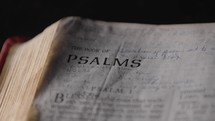 Light revealing a Bible and the book of Psalms