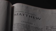Light revealing a Bible and the Gospel of Matthew