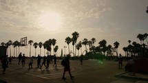 people playing basketball at venice beach at sunset