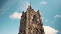 Tall church spire beneath a blue sky, place of worship video, historic architecture