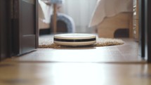 Automatic home cleaning. A Robot Vacuum Cleaner Vacuums on a Wooden Floor. Smart Housekeeping Housework.