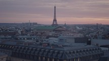 A stunning March sunset in Paris from the rooftop of Galeries Lafayette Haussmann, with the iconic Eiffel Tower towering among the city buildings.