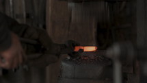 Blacksmith hammering metal 