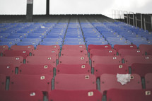 Red and blue seats in a sports stadium.