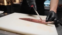 Chef cleaning a fresh fish 