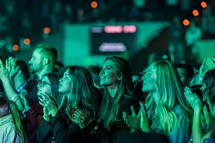 illuminated faces at a concert 