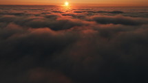 In heaven, flying above scenic clouds at sunrise