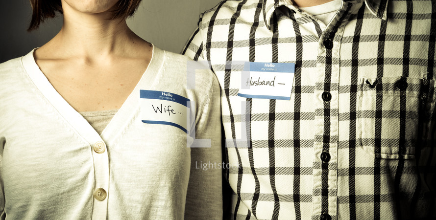 Couple wearing "husband" and "wife" name tags
