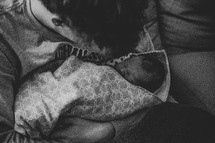 Person holding newborn baby - black and white