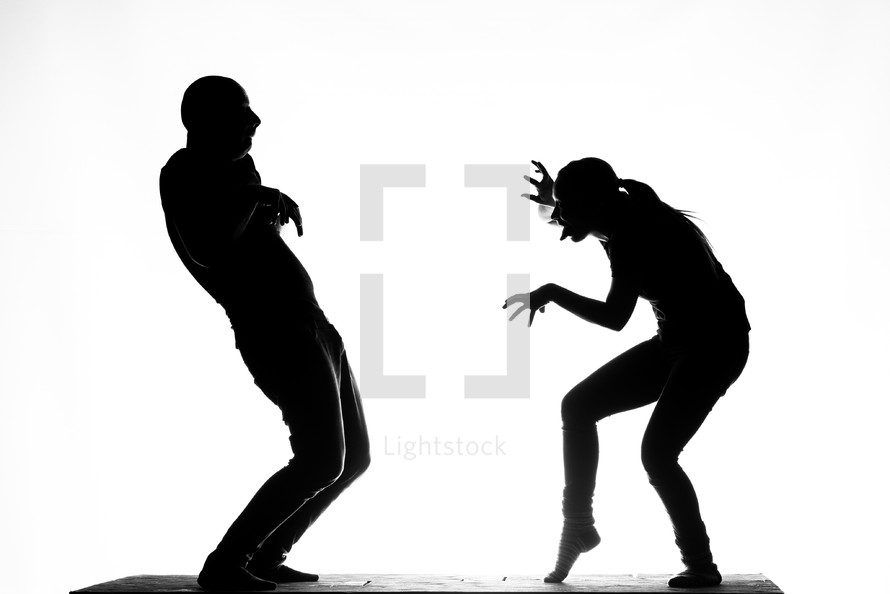 silhouettes of mimes on stage