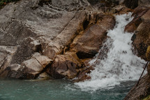 rocky shoreline with waterfall