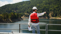 Engineer pointing to the edge structures on the artificial dam