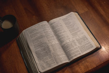 open Bible on a wooden table 