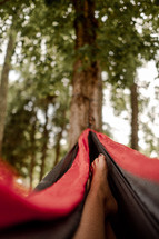 a person resting in a hammock 