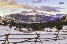 The summit of Longs Peak glows at sunrise after a fresh snowfall in Estes Park Colorado