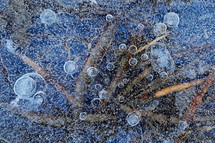 Closeup Frozen Water With Bubbles Of Air Caught Under The Ice