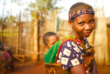 young African woman with a baby on her back 