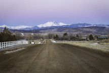 dirt road and distant snow capped mountains 
