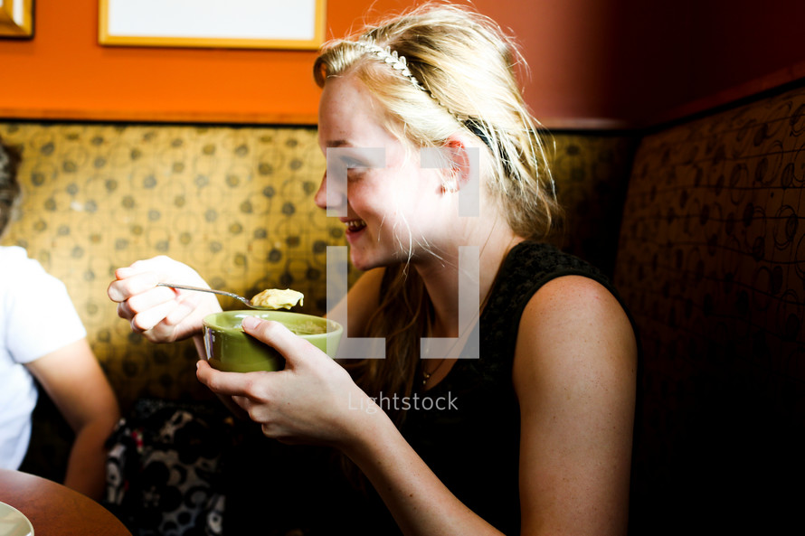 woman eating soup at a restaurant 