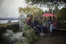 group of young women sitting outdoors 
