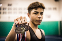 a teen boy with many medals 