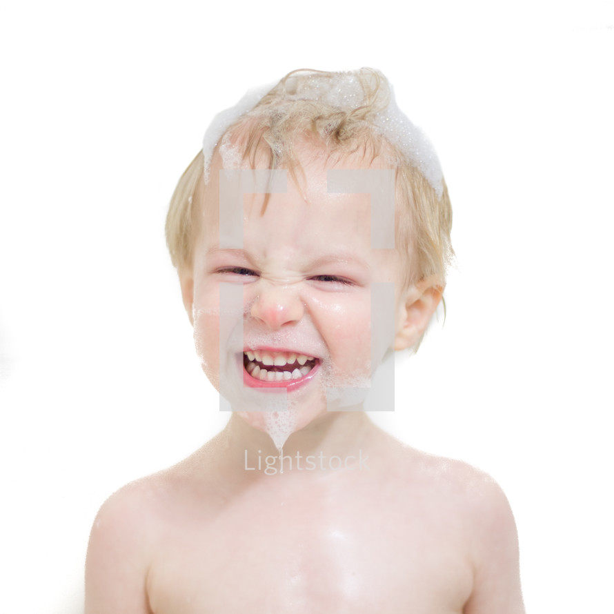 Smiling boy with soap on his face
