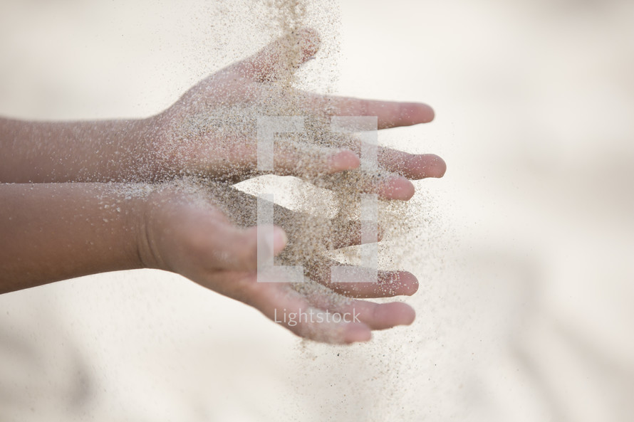sand through the hands of a child