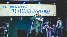 preacher on stage holding a microphone 