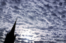 silhouette of a church steeple and clouds