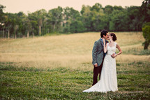 Bride and groom kissing outdoors