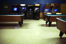 arcade games and pool tables at a bowling alley