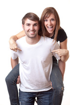 woman riding piggy back on a man pointing 