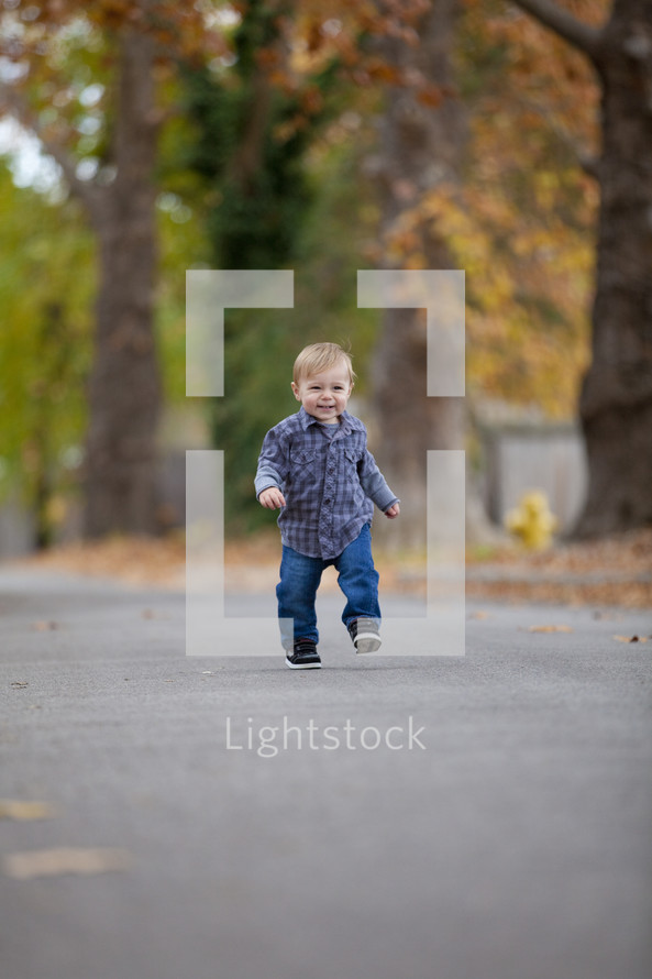 Toddler boy walking outside