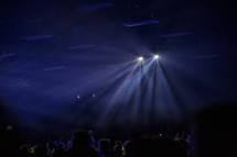 bright spotlights above an audience 
