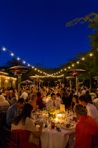 Outdoor reception dinner party event, lights night heaters
