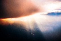 sunlight through a cloud from an airplane window